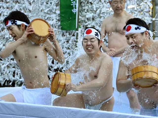 Believers of Shinto, the ethnic religion of Japan, pour cold water over themselves to purify their bodies and souls as part of an endurance show at the Kanda Shrine in Tokyo on Saturday. (AFP) Believers of Shinto, the ethnic religion of Japan, pour cold water over themselves to purify their bodies and souls as part of an endurance show at the Kanda Shrine in Tokyo on Saturday. (AFP)
