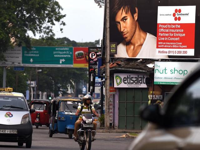 Sri Lankan commuters journey past a billboard in Colombo, associated with a concert of the Latin popstar Enrique Iglesias. Organisers have been publicly attacked by President Maithripala Sirisena for organising an “uncivilised “ concert by the pop star. (AFP Photo) Sri Lankan commuters journey past a billboard in Colombo, associated with a concert of the Latin popstar Enrique Iglesias. Organisers have been publicly attacked by President Maithripala Sirisena for organising an “uncivilised “ concert by the pop star. (AFP Photo)