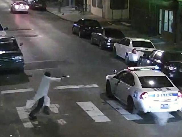 In this frame from a January 7 video, Edward Archer runs with a gun toward a police car driven by Officer Jesse Hartnett in Philadelphia. (AP) In this frame from a January 7 video, Edward Archer runs with a gun toward a police car driven by Officer Jesse Hartnett in Philadelphia. (AP)