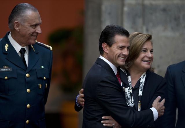 Mexican President Enrique Pena Nieto, center, hugs Attorney General Arely Gomez as National Defence Secretary Salvador Cienfuegos Zepeda looks on, during a press conference following the capture of fugitive drug lord Joaquin "El Chapo" Guzman. El Chapo’s escape in 2014 from the country’s most secure prison thoroughly embarrassed the Pena Nieto administration as well as highlighted the rampant corruption in the country. (AP Photo) Mexican President Enrique Pena Nieto, center, hugs Attorney General Arely Gomez as National Defence Secretary Salvador Cienfuegos Zepeda looks on, during a press conference following the capture of fugitive drug lord Joaquin "El Chapo" Guzman. El Chapo’s escape in 2014 from the country’s most secure prison thoroughly embarrassed the Pena Nieto administration as well as highlighted the rampant corruption in the country. (AP Photo)