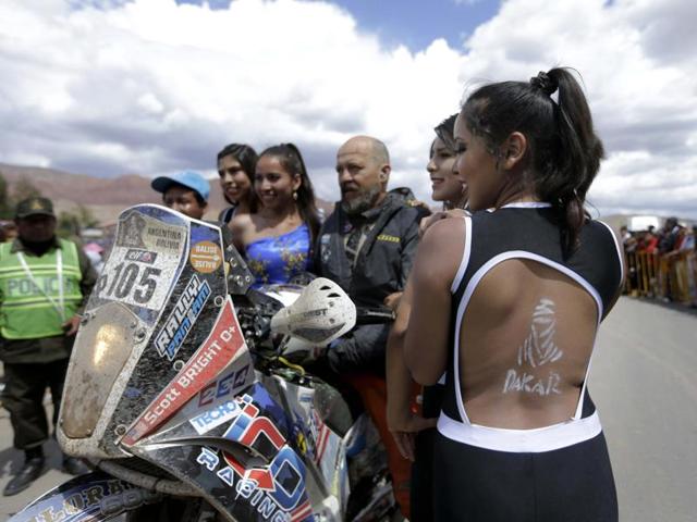KTM rider Scott Bright of the U.S., poses for a picture with fans during the 7th stage of the 2016 Dakar Rally, in the Bolivian town of Tupiza, between Uyuni, Bolivia and Salta, Argentina. (AP Photo/Jorge Saenz)