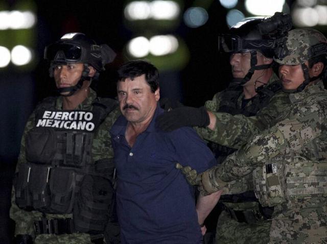 Mexican drug lord Joaquin "El Chapo" Guzman is escorted by army soldiers to a waiting helicopter, at a federal hangar in Mexico City. (AP) Mexican drug lord Joaquin "El Chapo" Guzman is escorted by army soldiers to a waiting helicopter, at a federal hangar in Mexico City. (AP)