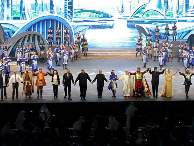 Lebanese director Ziad Rahbani (4th R) and members of the cast hold hands during the premiere of Al Faris or The Knight, a musical set to poetry penned by Dubai's monarch Sheikh Mohammed bin Rashid al-Maktoum. (REUTERS) 