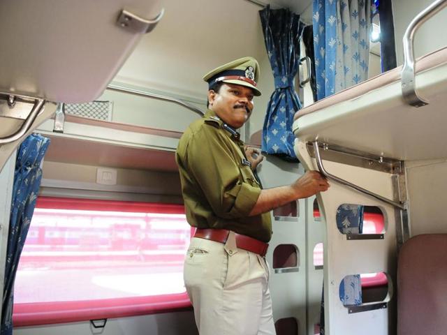 A RPF officer inspects the AC 2 tier of the newly-built model coaches at Habibganj railway station in Bhopal. (Mujeeb Faruqui/HT Photo)