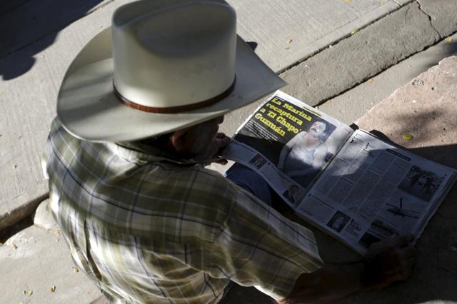 A resident reads a newspaper article about the recapture of Joaquin "Chapo" Guzman at a plaza in the municipality of Badiraguato, in Sinaloa state, Mexico, January 9, 2016. Many residents of Guzman’s home town view him as a latter-day Robin Hood who brought jobs to the poor. (REUTERS) A resident reads a newspaper article about the recapture of Joaquin "Chapo" Guzman at a plaza in the municipality of Badiraguato, in Sinaloa state, Mexico, January 9, 2016. Many residents of Guzman’s home town view him as a latter-day Robin Hood who brought jobs to the poor. (REUTERS)