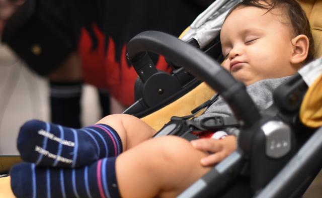 An infant sleeps in a crib during the "No Pants Subway Ride" on a New York City subway platform. (AFP Photo) An infant sleeps in a crib during the "No Pants Subway Ride" on a New York City subway platform. (AFP Photo)