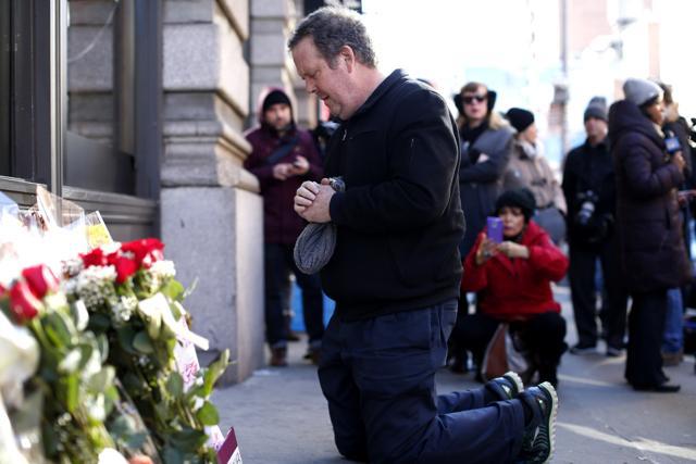 A man prays at a memorial outside of the residence of British music legend David Bowie in New York on January 11, 2016. (AFP) A man prays at a memorial outside of the residence of British music legend David Bowie in New York on January 11, 2016. (AFP)