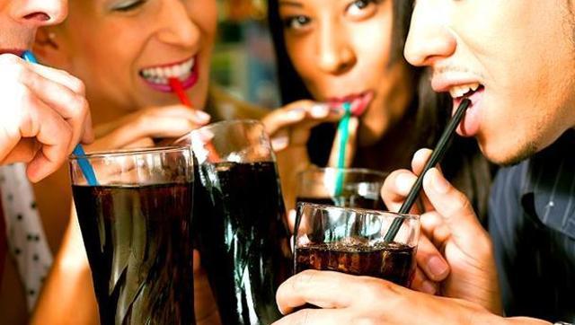 People who drink sugar-sweetened beverages tend to develop more belly fat, which is associated with a risk of diabetes and heart disease. (Shutterstock)