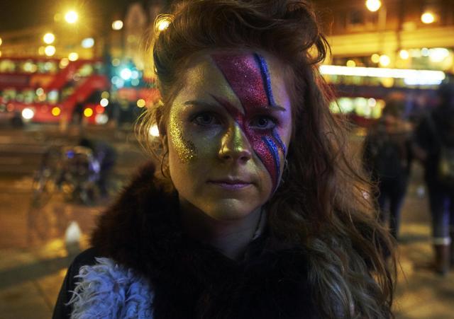 A woman with a painted face stands outside the Ritzy cinema in south London to pay homage to British singer David Bowie following the announcement of Bowie's death on January 11, 2016. (AFP) A woman with a painted face stands outside the Ritzy cinema in south London to pay homage to British singer David Bowie following the announcement of Bowie's death on January 11, 2016. (AFP)