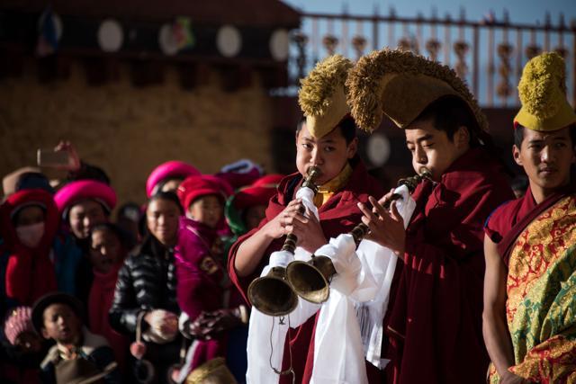 This picture taken at the Ganden Sumtsenling Monastery in Shangri-La, Diqing Tibetan Autonomous Prefecture of southwest China's Yunnan Province, shows lamas playing traditional instruments during the Gedong festival. Thousands of metres above sea level, high on the Tibetan plateau, hundreds of Tibetan Buddhist devotees in brilliant hues of pink and blue gathered for the Gedong festival. Lamas young and old mixed with festival-goers wearing traditional garb to watch the religious Cham dance at the Ganden Sumstseling monastery in Shangri-La. Masked, costumed monks portrayed a host of ghosts and deities from the pantheon of Tibetan Buddhist mythology, to the sounds of lamas playing traditional instruments -- crashing cymbals, drums and deep, vibrating ceremonial horns. (AFP)