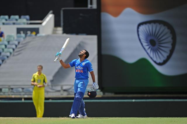India's Rohit Sharma raises his bat after reaching his century. (AFP Photo)
