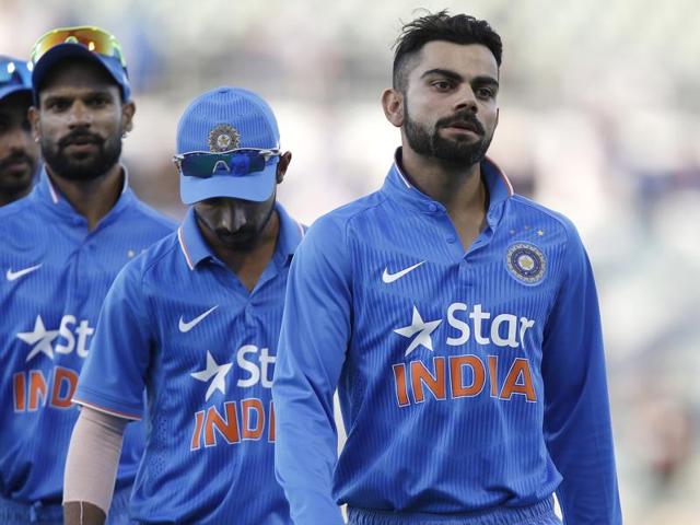 India's Virat Kohli walks off the ground with teammates after being defeated by Australia. (AP Photo)