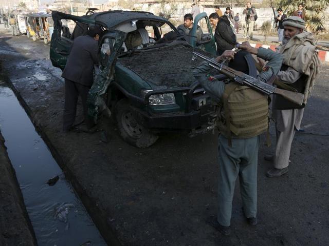Afghan security personnel stand next to a damaged police vehicle after a blast near the Pakistani consulate in Jalalabad, Afghanistan. (Reuters Photo) Afghan security personnel stand next to a damaged police vehicle after a blast near the Pakistani consulate in Jalalabad, Afghanistan. (Reuters Photo)