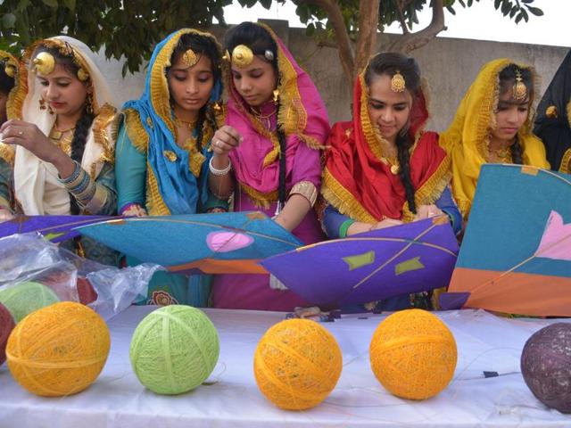 School girls prepare to fly kites during Lohri celebrations in Amritsar on Wednesday. (AFP)