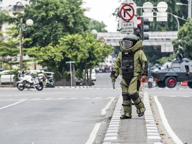 A member of the police bomb squad unit approaches the scene of an explosion following an attack on a police box in central Jakarta. (Reuters Photo) 
