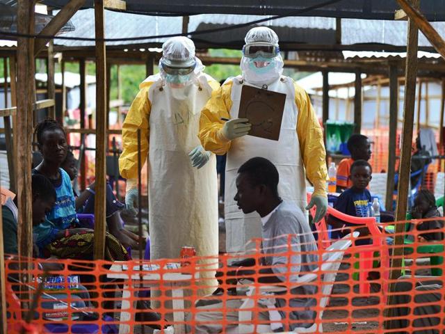 A MSF medical worker, wearing protective clothing relays patient details and updates behind a barrier to a colleague at an MSF facility in Kailahun. The World Health Organization (WHO) announced that the Ebola epidemic was over after Liberia, the last affected country, received the all-clear. (AFP File Photo) A MSF medical worker, wearing protective clothing relays patient details and updates behind a barrier to a colleague at an MSF facility in Kailahun. The World Health Organization (WHO) announced that the Ebola epidemic was over after Liberia, the last affected country, received the all-clear. (AFP File Photo)