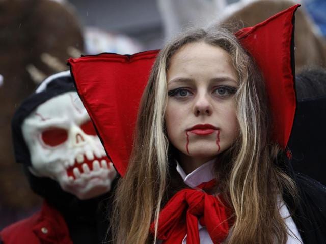 A young woman wearing a costume walks in the carnival on Wednesday. The festival has its roots in the pre-Christian beliefs and rituals of the region. (AP)