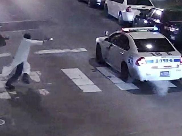 A still image from surveillance video shows a gunman (L) approaching a Philadelphia Police vehicle in which officer Jesse Hartnett was shot in Philadelphia. (Philadelphia Police Department/ via Reuters Photo) A still image from surveillance video shows a gunman (L) approaching a Philadelphia Police vehicle in which officer Jesse Hartnett was shot in Philadelphia. (Philadelphia Police Department/ via Reuters Photo)