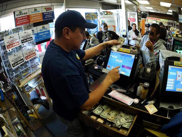 7-Eleven store clerk M. Faroqui celebrates after learning the store sold the only winning Powerball ticket on Wednesday. (AP) 7-Eleven store clerk M. Faroqui celebrates after learning the store sold the only winning Powerball ticket on Wednesday. (AP)
