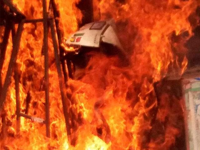 Remains of a vehicle which was set ablaze during communal clashes in Fatehpur district.(PTI) Remains of a vehicle which was set ablaze during communal clashes in Fatehpur district.(PTI)