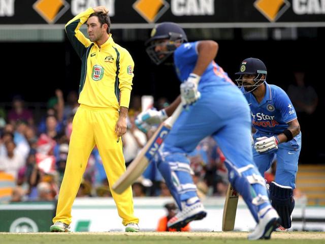 Australia's Glenn Maxwell (L) reacts after being hit for a boundary by Rohit Sharma (C), as he runs between the wickets with teammate Virat Kohli. (Reuters Photo) Australia's Glenn Maxwell (L) reacts after being hit for a boundary by Rohit Sharma (C), as he runs between the wickets with teammate Virat Kohli. (Reuters Photo)