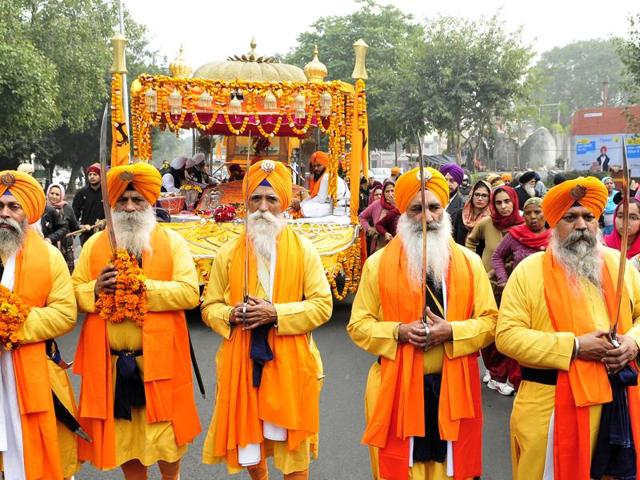 Sikh devotees walking through the town to spread the message of God during the Nagar Kirtan in SAS Nagar on Thursday. (Keshav Singh/HT Photo)