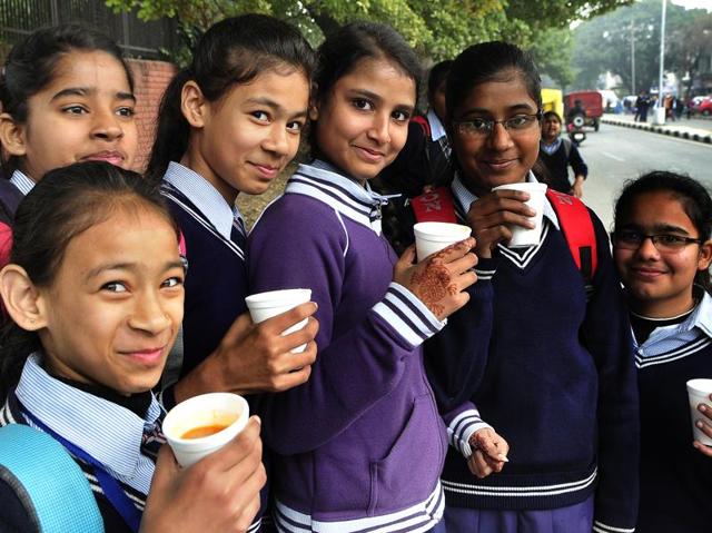 School kids enjoy tea and pose for pictures on Thursday. (Keshav Singh/HT Photo)