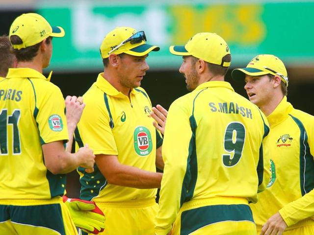Australian captain Steven Smith (R) is congratulated by teammates following the dismissal of India's Ajinkya Rahane in Brisbane. (AFP Photo) 