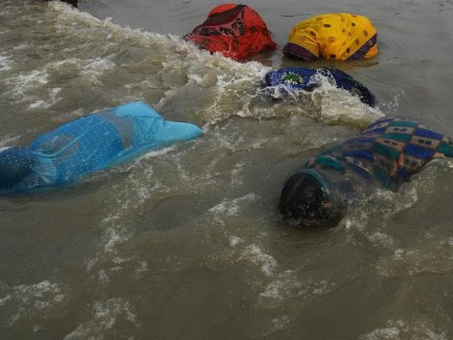 Hindu devotees take a holy bath before performing rituals during the Gangasagar Mela on the occasion of Makar Sankranti at Gangasagar Island, some 150 km south of Kolkata, on Thursday. (AFP) Hindu devotees take a holy bath before performing rituals during the Gangasagar Mela on the occasion of Makar Sankranti at Gangasagar Island, some 150 km south of Kolkata, on Thursday. (AFP)