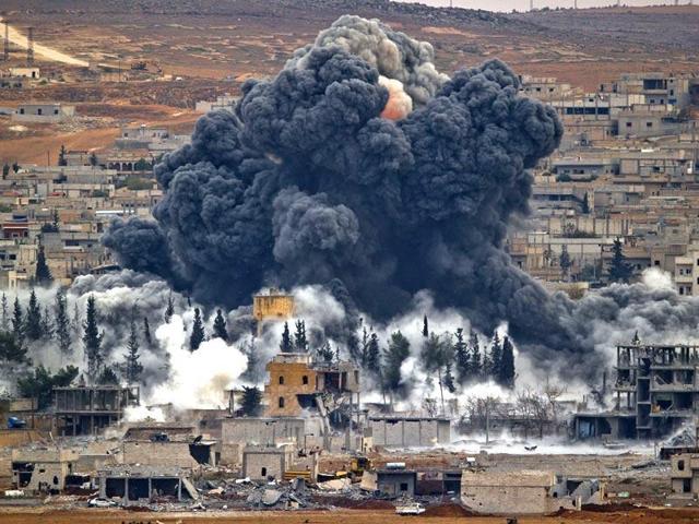 Smoke rises from the Syrian city of Kobani, following an airstrike by the US-led coalition against Islamic State. A US military report has stated that at least 8 civilians have been killed in the airstrikes, which have been aimed at IS targets. (AP Photo) Smoke rises from the Syrian city of Kobani, following an airstrike by the US-led coalition against Islamic State. A US military report has stated that at least 8 civilians have been killed in the airstrikes, which have been aimed at IS targets. (AP Photo)