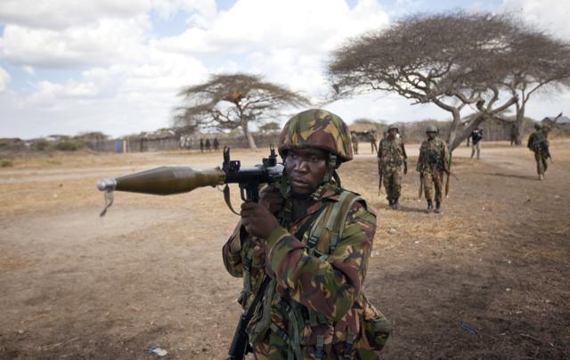 A Kenyan army soldier carries a rocket-propelled grenade launcher as he patrols in Tabda, inside Somalia. Heavily armed fighters from the Islamic extremist group Al Shabaab attacked a base for African Union peacekeepers in southwestern Somalia on Friday. (AP Photo) A Kenyan army soldier carries a rocket-propelled grenade launcher as he patrols in Tabda, inside Somalia. Heavily armed fighters from the Islamic extremist group Al Shabaab attacked a base for African Union peacekeepers in southwestern Somalia on Friday. (AP Photo)