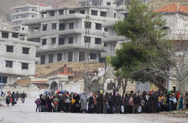 Residents of the besieged rebel-held Syrian town of Madaya wait for a convoy of aid from the Syrian Arab Red Crescent. (AFP Photo) Residents of the besieged rebel-held Syrian town of Madaya wait for a convoy of aid from the Syrian Arab Red Crescent. (AFP Photo)