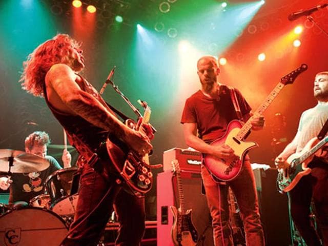 Baroness (left, with frontman and guitarist John Baizley in the centre) performs in Chicago in 2012.(Corbis) Baroness (left, with frontman and guitarist John Baizley in the centre) performs in Chicago in 2012.(Corbis)