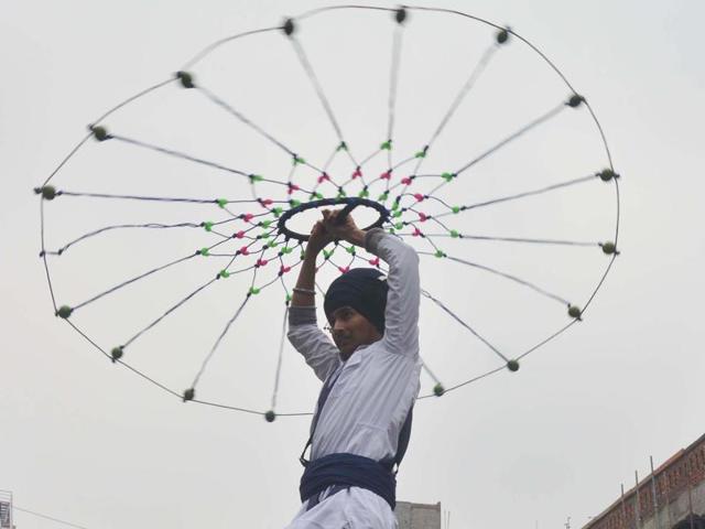 A young religious Sikh warrior performing the Gatka during the procession on Friday in Amritsar. (Sameer Sehgal/HT )