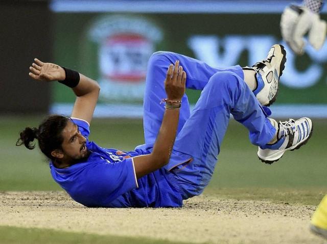 Ishant Sharma falls to the ground after bowling to Australia's James Faulkner. (AP)