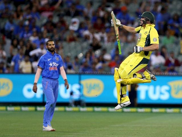 Australia's James Faulkner celebrates hitting the winning runs as India's Shikhar Dhawan watches during their One Day cricket match at the Melbourne Cricket Ground. (REUTERS)