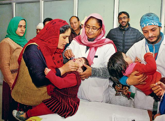Health officials administer polio vaccine drops to children at a government hospital in Jammu on Sunday. (PTI Photo) Health officials administer polio vaccine drops to children at a government hospital in Jammu on Sunday. (PTI Photo)