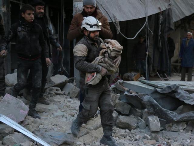 A Syrian Civil Defence worker carries a child wrapped in a blanket over the rubble following a reported air strike by Syrian government forces on the Sukkari neighborhood of Syria's northern city of Aleppo. (AFP) A Syrian Civil Defence worker carries a child wrapped in a blanket over the rubble following a reported air strike by Syrian government forces on the Sukkari neighborhood of Syria's northern city of Aleppo. (AFP)