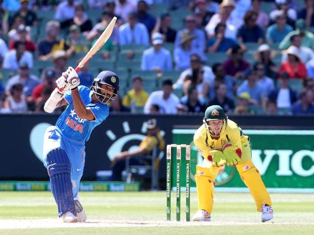 India's Shikhar Dhawan (L) cover drives with Australia's Matthew Wade (R) watching during their One Day cricket match at the Melbourne Cricket Ground. (REUTERS)