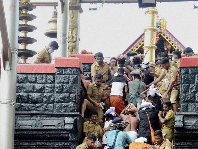 Police help devotees seeking a glimpse of Lord Ayyappa at Sabarimala in this file photo. (PTI) Police help devotees seeking a glimpse of Lord Ayyappa at Sabarimala in this file photo. (PTI)