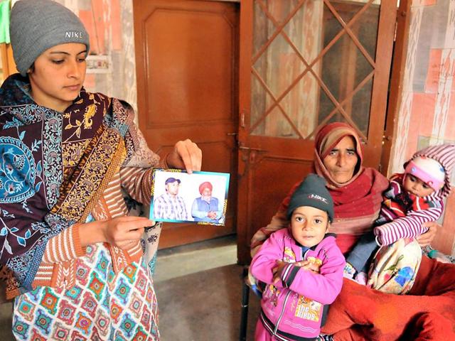 Gurpreet Kaur, wife of Gurwinder, one of the youths feared dead in the Panama boat tragedy, showing his photograph with her children in Tandi Aulakh village in Kapurthala village on Monday. (Pradeep Pandit/HT Photo) Gurpreet Kaur, wife of Gurwinder, one of the youths feared dead in the Panama boat tragedy, showing his photograph with her children in Tandi Aulakh village in Kapurthala village on Monday. (Pradeep Pandit/HT Photo)