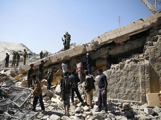 Policemen and people search for victims at the site of a Saudi-led airstrike on the police headquarters in Sanaa. (AP) Policemen and people search for victims at the site of a Saudi-led airstrike on the police headquarters in Sanaa. (AP)