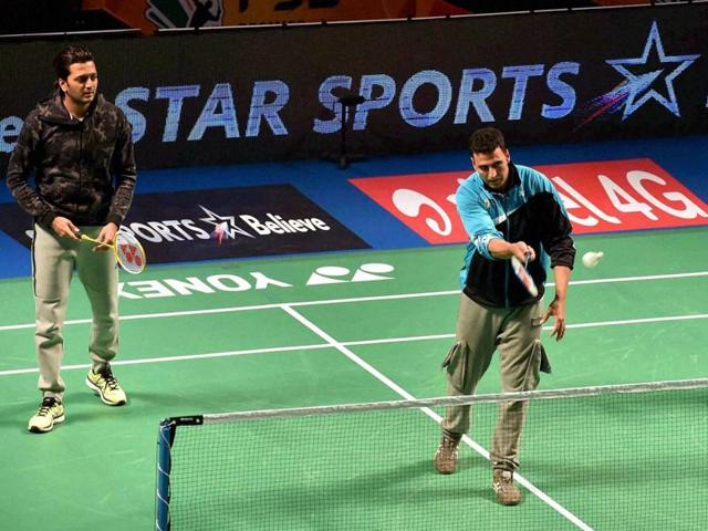 Akshay Kumar plays badminton during the Premier Badminton League's Mix doubles match in New Delhi on Sunday.  (PTI) 
