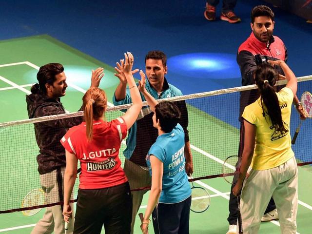 Bollywood actors and Badminton players playing a friendly match during the Premier Badminton League's Mix doubles match in New Delhi.  (PTI) 