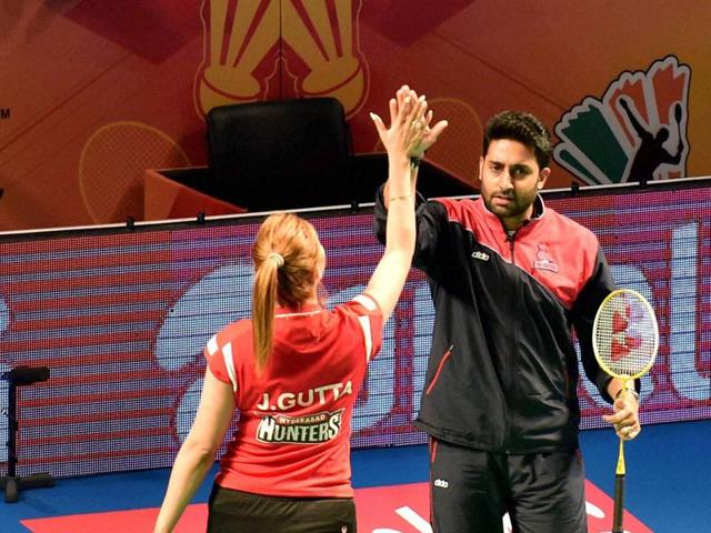 Bollywood actor Abhishek Bachchan with Jwala Gutta during a friendly match at the Premier Badminton League's Mix doubles match in New Delhi on Sunday. (PTI) 
