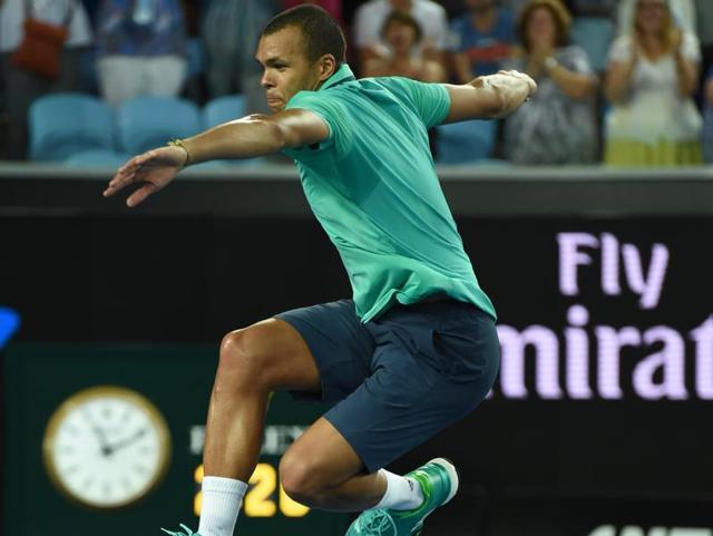 France's Jo-Wilfried Tsonga leaps into the air as he celebrates victory in his men's singles match against Cyprus Marcos Baghdatis. (AFP Photo)
