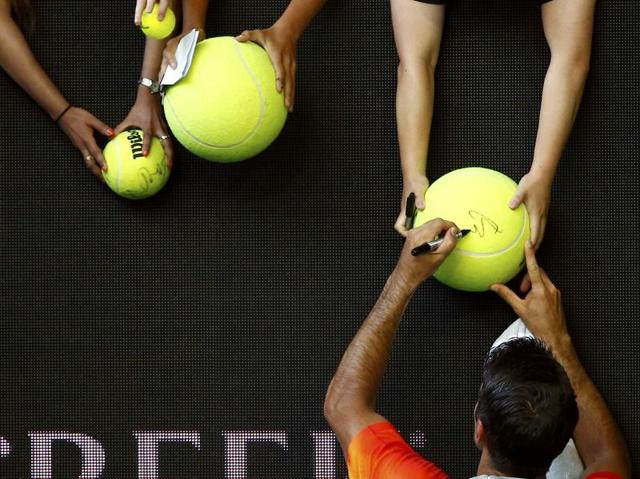 Spain's Fernando Verdasco signs autographs after winning his first round match against Spain's Rafael Nadal. (Thomas Peter/ REUTERS/) 