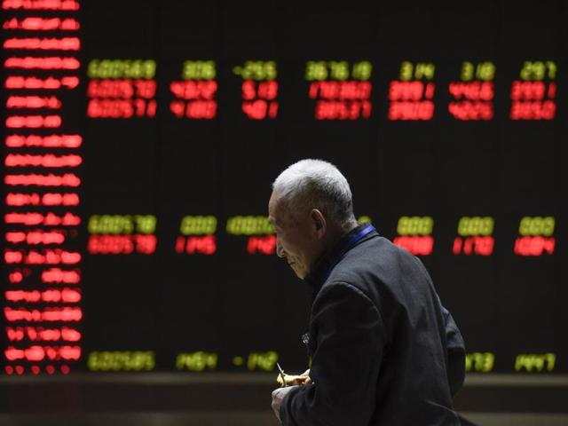 Investors are seen in front of an electronic board showing stock information at a brokerage house in Beijing. China’s rate of growth has fallen to its worst since 2009. (AFP Photo) Investors are seen in front of an electronic board showing stock information at a brokerage house in Beijing. China’s rate of growth has fallen to its worst since 2009. (AFP Photo)