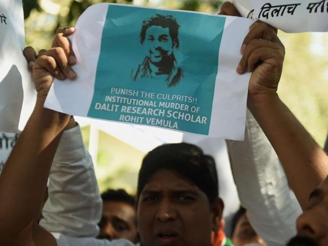 Congress workers holds a placard with a photo of Dalit scholar Rohith Vemula during a protest in Delhi.  (AFP PHOTO / Punit Paranjpe) 