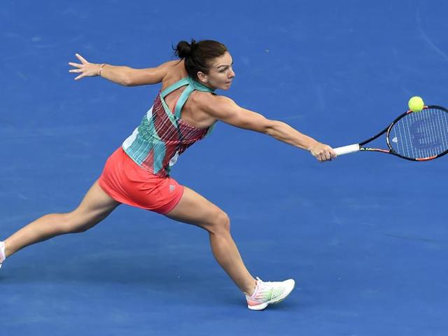 Simona Halep of Romania makes a backhand return to to Zhang Shuai of China during their first round match. (Andrew Brownbill/ AP Photo) 